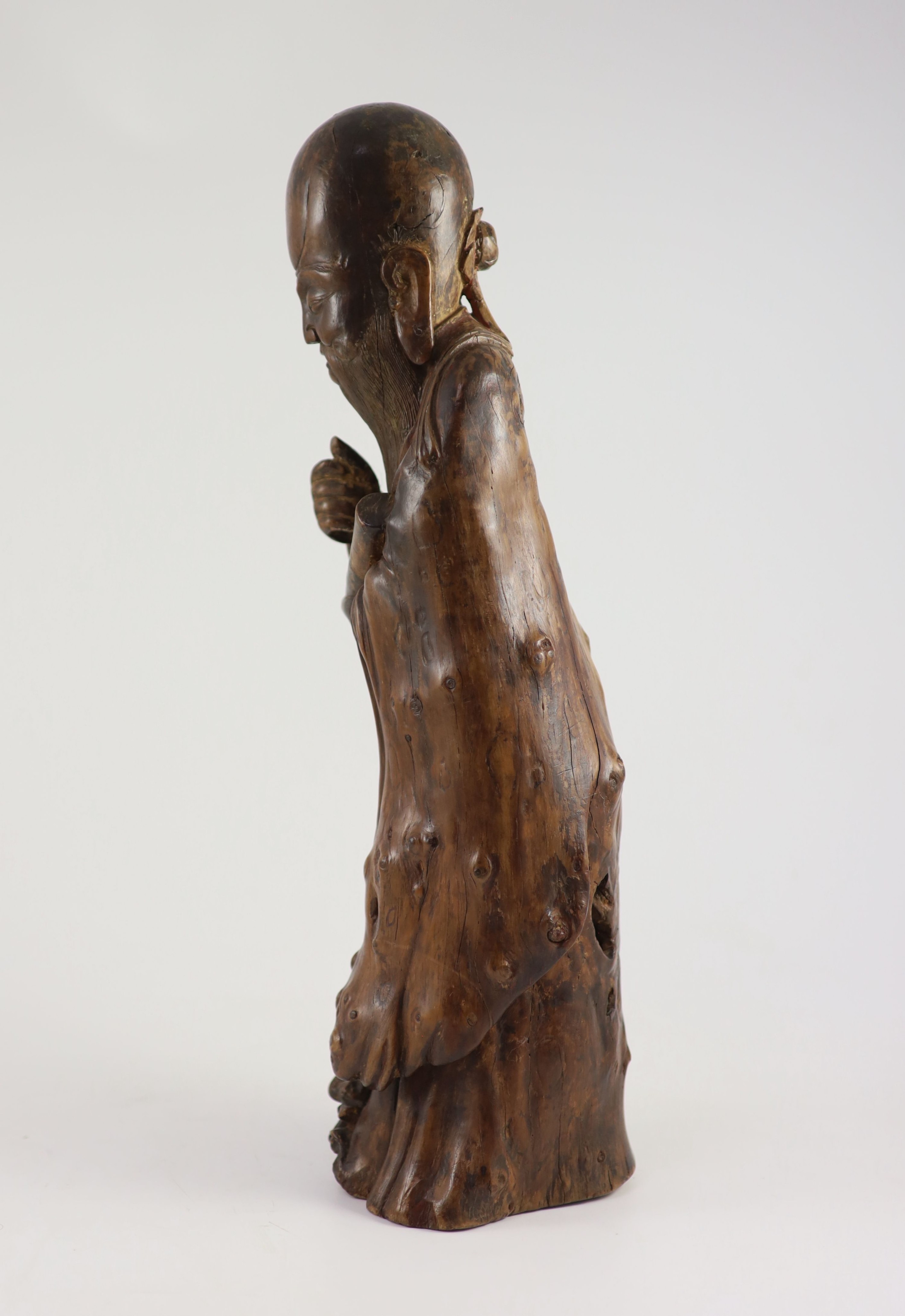 A tall Chinese rootwood figure of Shou Lao, 17th/18th century, 46 cm high, missing the staff in his right hand